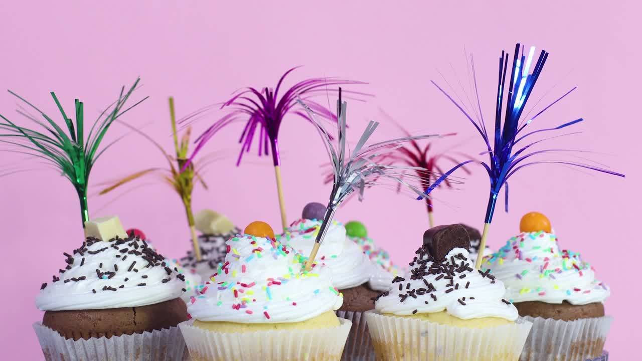 Party decorated cup cakes with white cream and crumbs