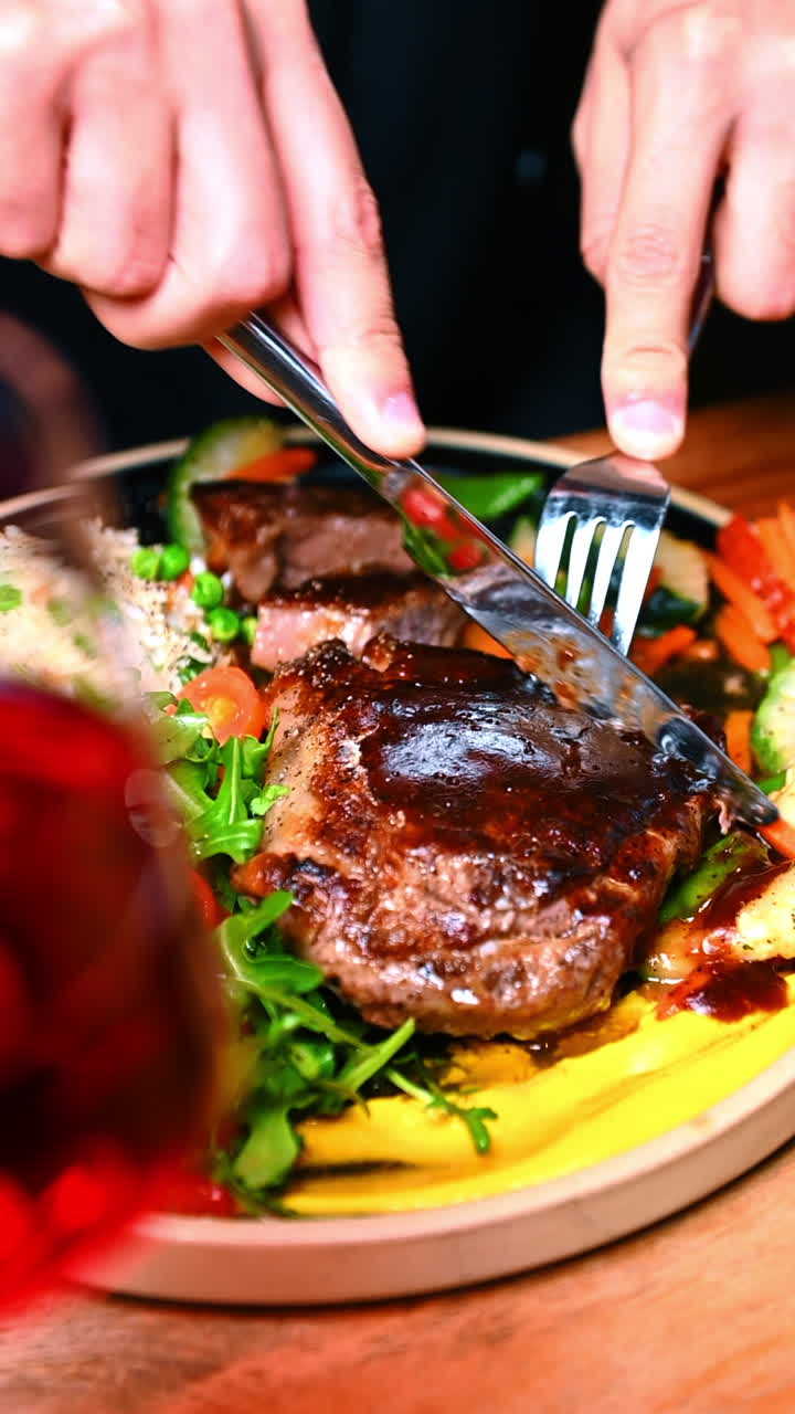 Steak served with rice and greens. Juicy steak lies next to seasoned rice and fresh greens