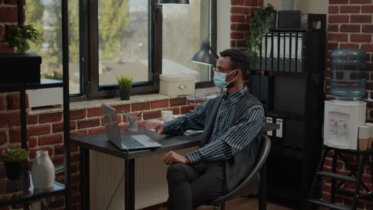 Employee with face mask using video call communication