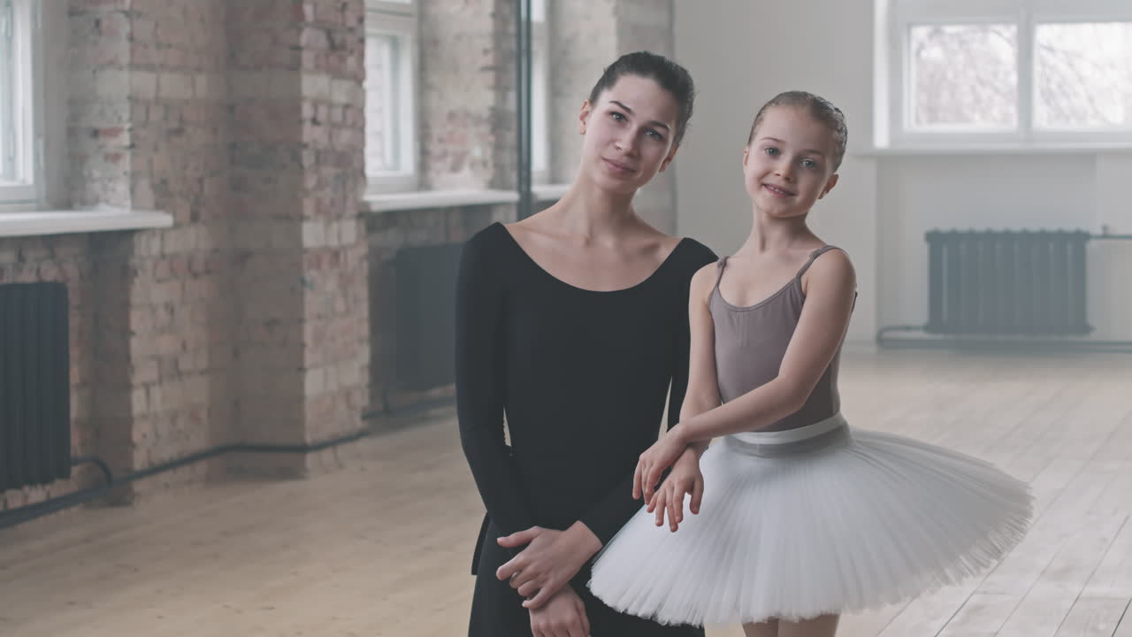 Ballet Tutor Teaching Pretty Girl In Dance Studio