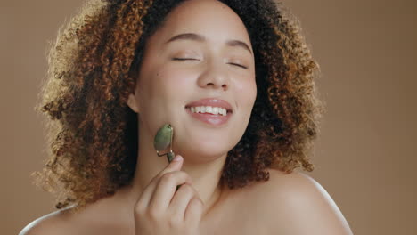 jade roller, face and black woman in studio
