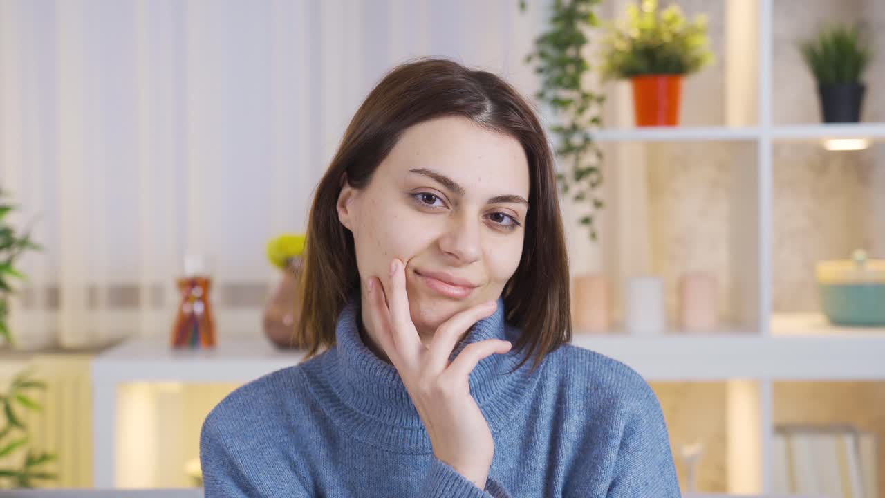 hermosa joven acariciando su piel mirando a la cámara y sonriendo.