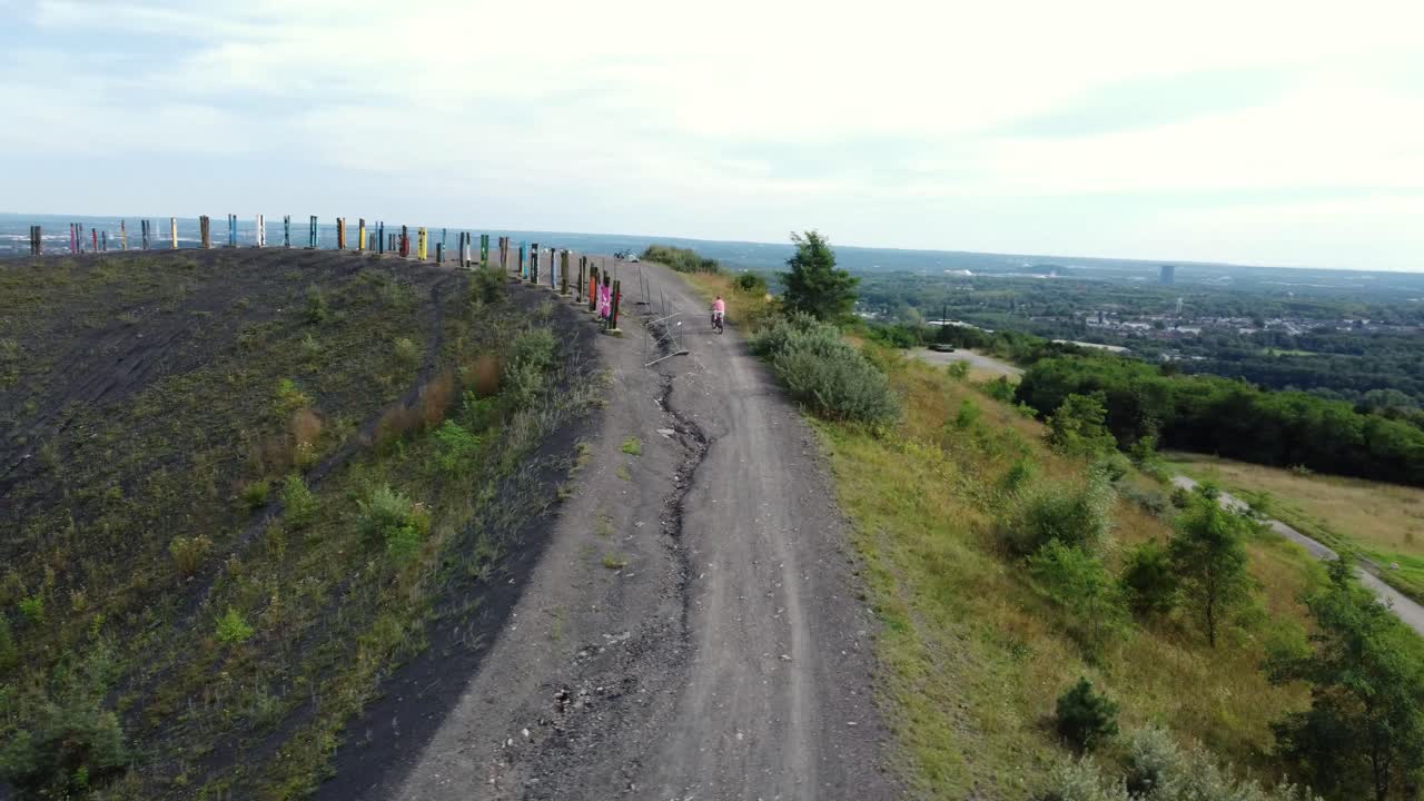 Scenic Hillside with Dirt Road and Distant City View