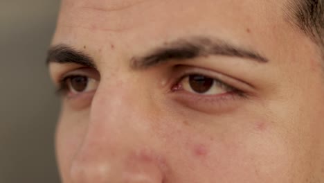 side view of handsome young man with brown eyes looking aside