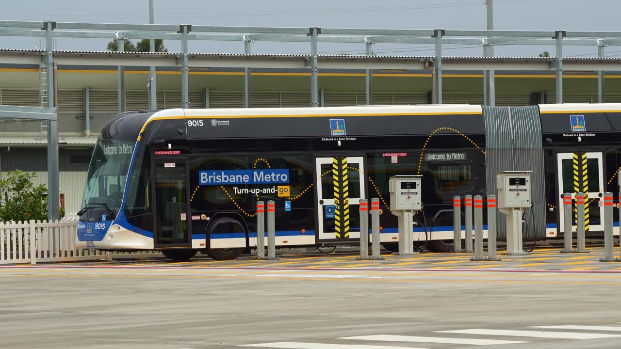 Electric bi-articulated vehicle, Metro bus parked at the off-peak slow charging station in Rochedale depot, innovative bus rapid transit system in Queensland.