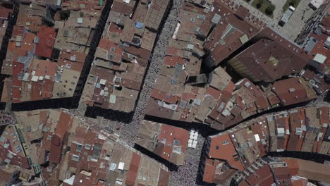 bird's eye view aerial: tourist visitors gathered on pamplona streets