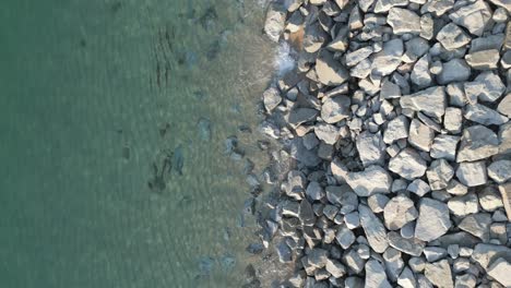 aerial drone view of sea shore, rocks and blue transparent sea water of arenys de mar, catalonia, barcelona spain