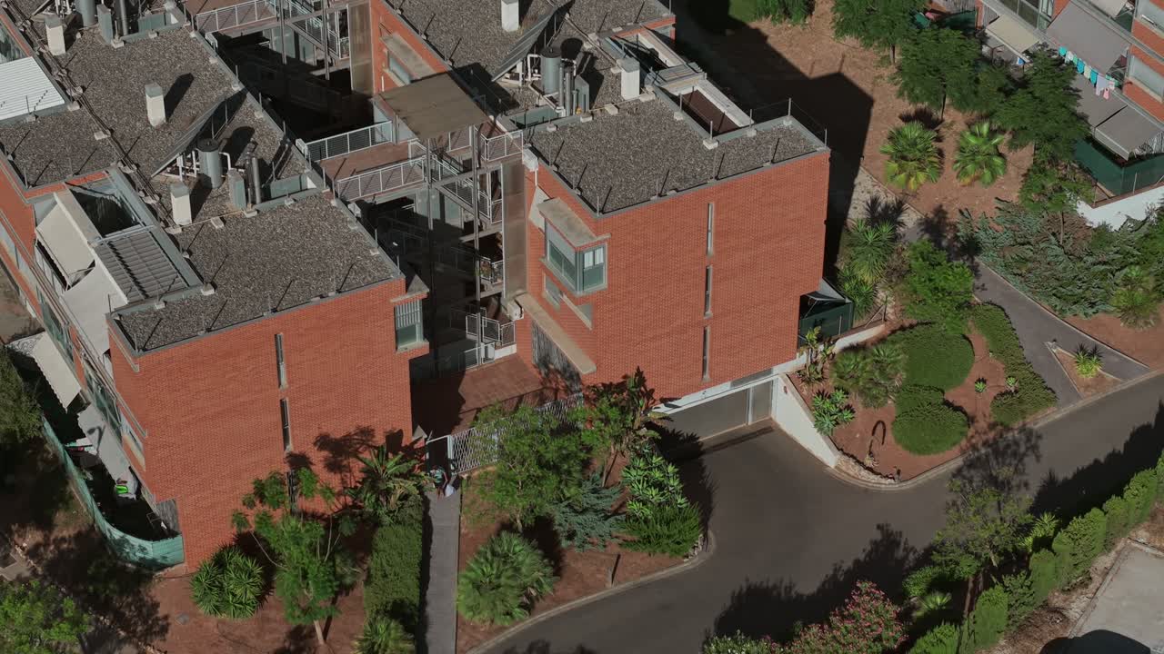 Modern brick residential building and peaceful neighborhood vibe, aerial view