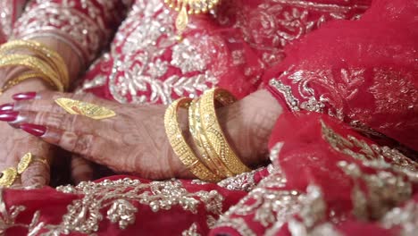 bride's hands with gold jewelry and henna