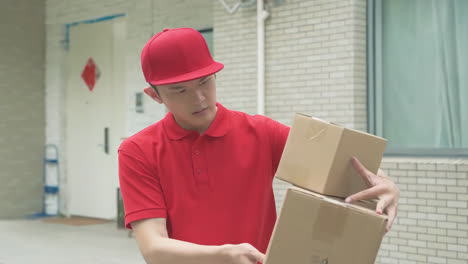 delivery man uniform smiles during express delivered the wrong package, courier holding a small parcel delivering goods to customer's home with van truck, door-to-door services