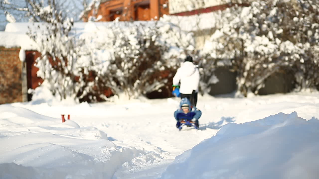 Mother and child on snow. Happy joyful mother and child walking on snow