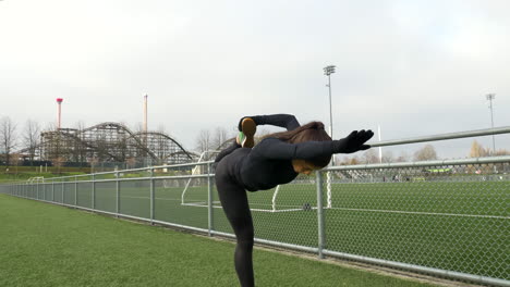 girl in black sportswear stretching legs after workout, slow motion