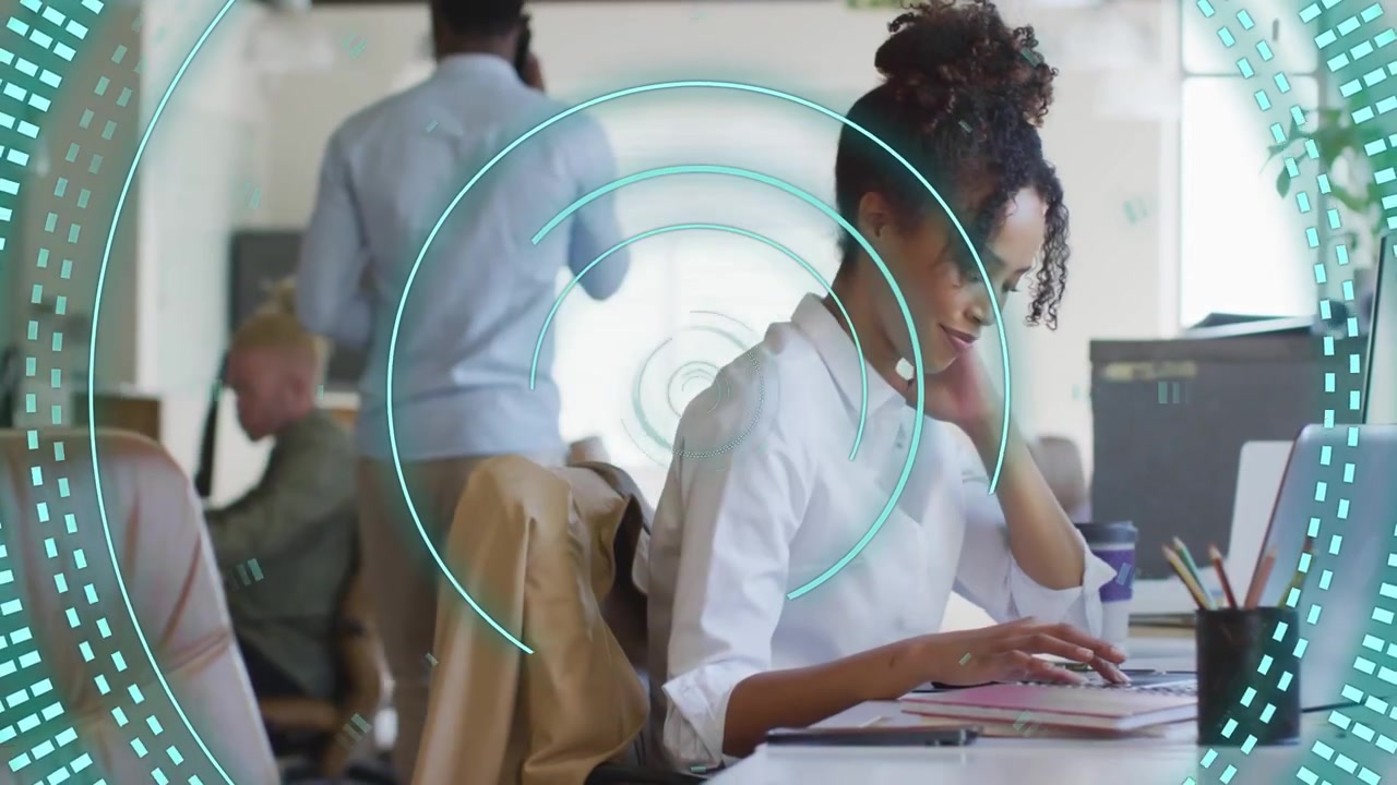 Teal HUD clearing and revealing woman typing and scrolling at laptop, highlighting office work