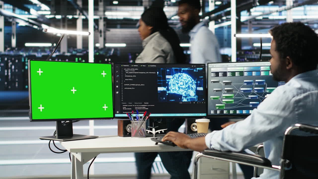 Data center admin in wheelchair using AI node tree software on green screen PC