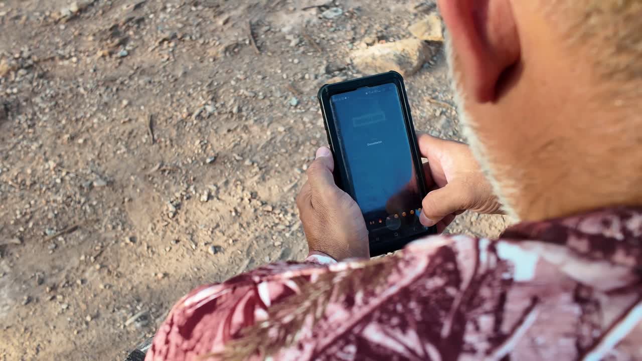 Man chats on mobile phone, downwards shot. Ecology and Technology Concept