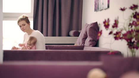 mother with baby at home. mother holding a baby in cozy room