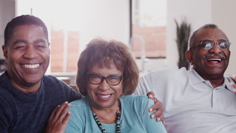 Happy-middle-aged-black-couple-and-parents-relax-sitting-together-at-home,-close-up