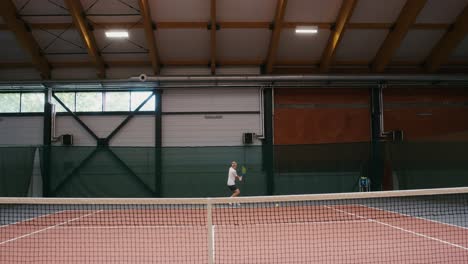 man playing tennis indoor