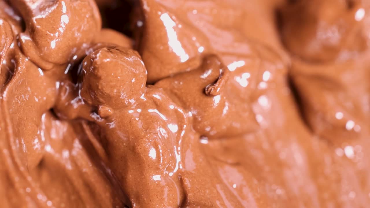 Detailed view of glossy chocolate with rich, creamy textures and swirls.