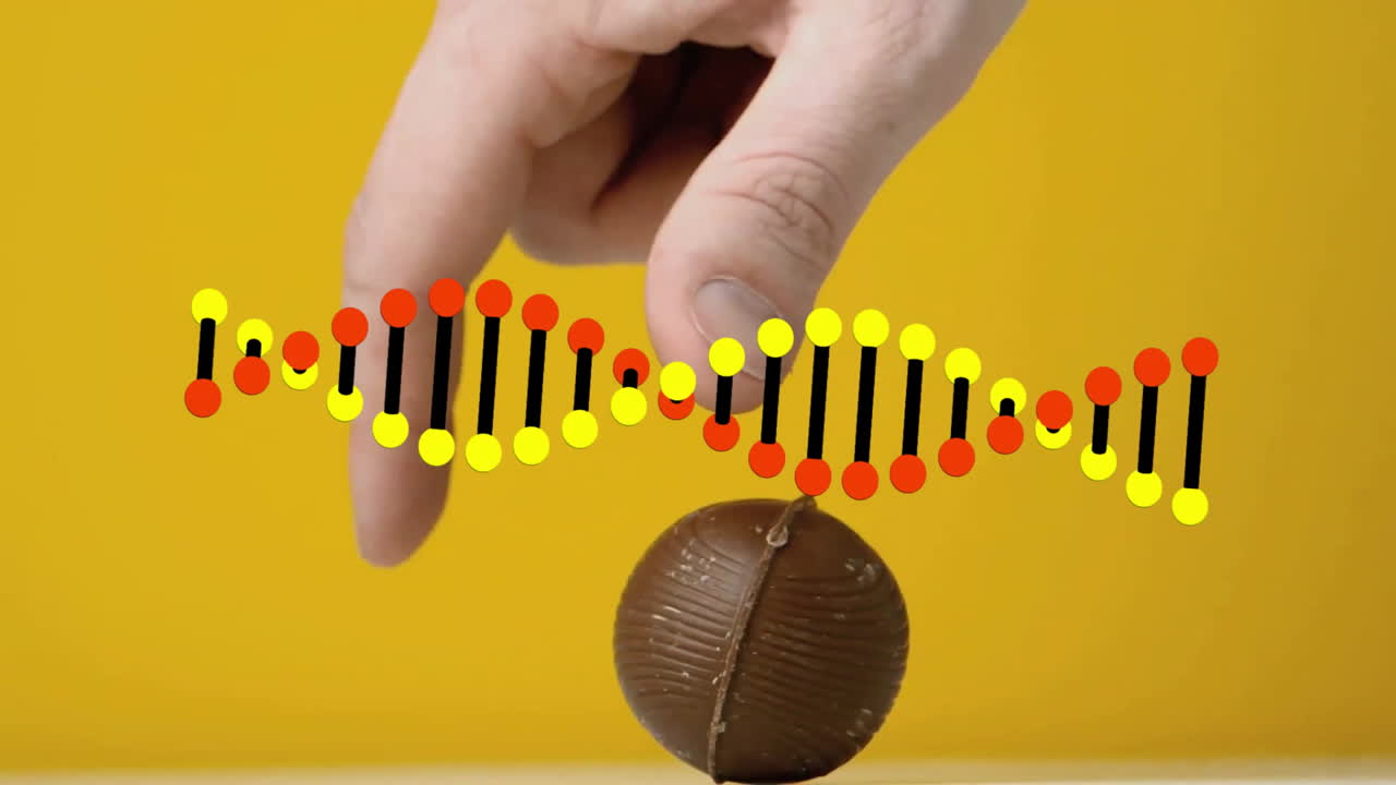 Hand reaching for chocolate with DNA strand animation over yellow background