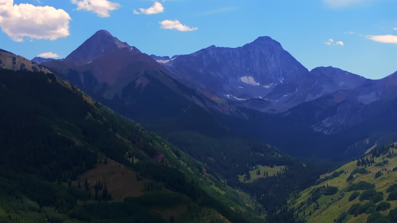 Capitol Peak Aspen Snowmass Wilderness spring summer aerial drone parallax Colorado Elk Range Rocky Mountains 14er Capitol Creek Trailhead Aspen grove White River National Forest valley upwards