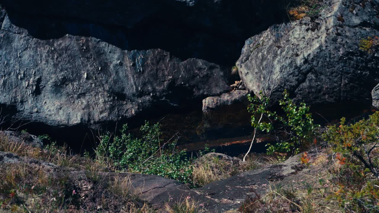 Water Flowing Through Huge Rocks In Skurven Mountain, Indre Fosen, Norway. high angle, panning shot