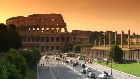 the coliseum in rome with traffic passing 3
