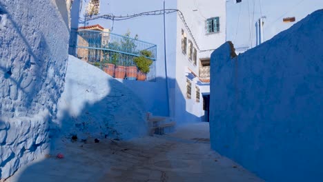 POV-Walking-Up-Steep-Street-In-Chefchaouen-Leading-To-Small-Courtyard