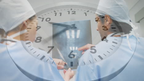 animation of clock over diverse male and female surgeons discussing over x-ray report at hospital