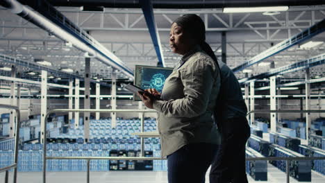 it expert monitors server farm activity while walking on industrial platform