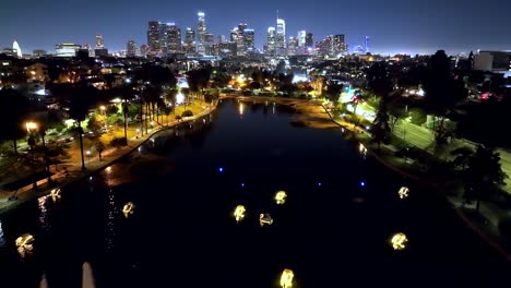 lago echo park con el horizonte de la ciudad de los ángeles al atardecer - paso elevado aéreo