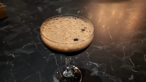 Fresh-Coffee-in-a-Wine-Glass-with-Frothy-Bubbles-Close-Up-Overhead-Shot