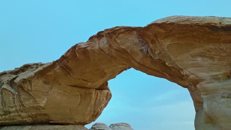 burdah rock bridge in wadi rum, jordan at daytime - aerial drone shot