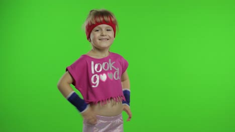 Little-girl-in-pink-sportswear-tells-something-and-showing-thumb-up-gesture.-Chroma-key-background