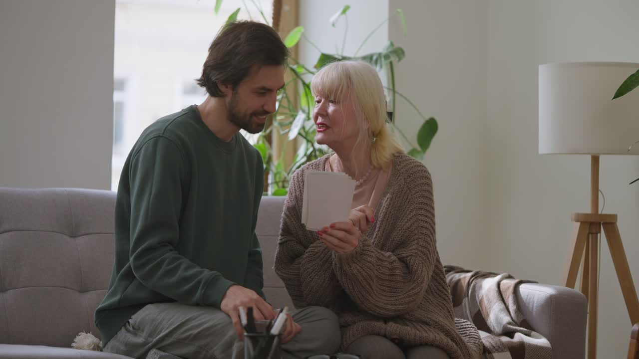 Grandmother and Grandson Looking at Old Photographs