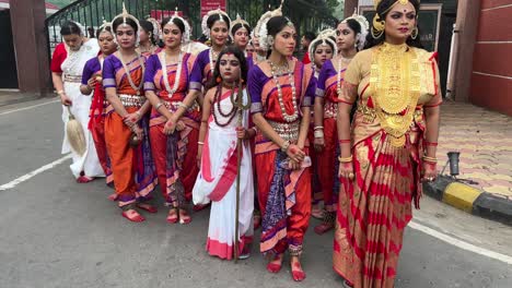 shot of women and girl dressed as hindu gods for durga puja procession to be held at red road in kolkata, india.