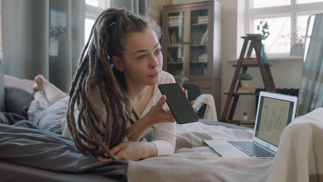Female Digital Designer Resting In Bed