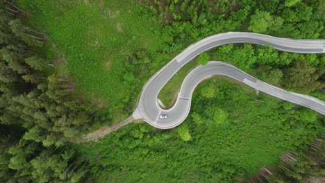 4K-overhead-drone-shot-of-cars-driving-on-a-winding-serpentine-road