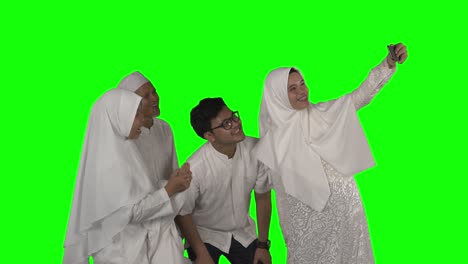 three generation muslim family take selfie on studio