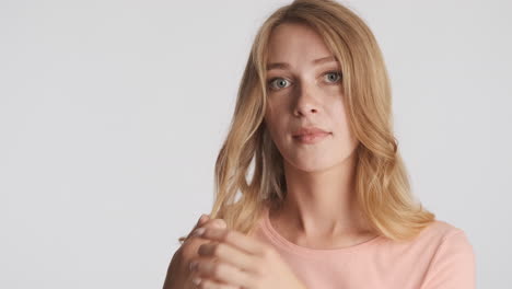 caucasian woman playing with hair on camera.