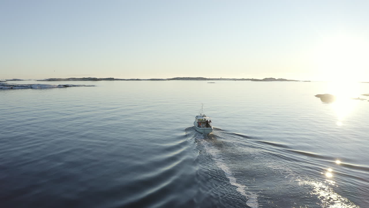 Drone shot of a fishing boat sailing out at sea at Gothenburg archipelago, Sweden