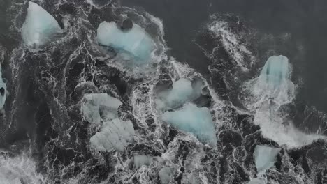 slow motion shot of waves on black sand beach