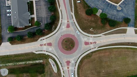 crisp, clean overhead aerial of vehicles moving through a roundabout traffic passing