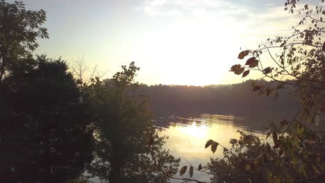 aerial shot of a sunrise over a lake