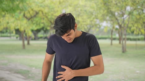 young indian man having stomach pain