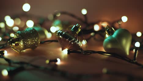 close-up shot of garland with golden lights and christmas toys on color background. christmas concept. home decor. beautiful bokeh