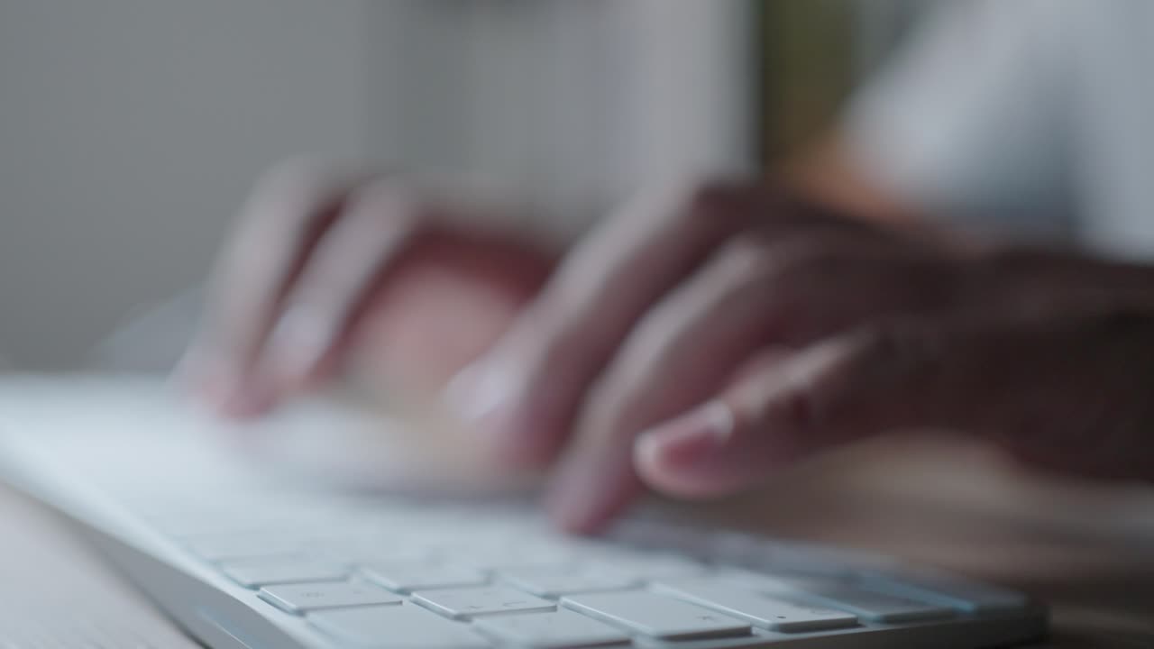 close up hands working overtime typing research laptop office desk at night