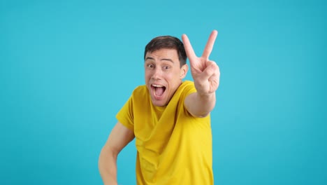 man gesturing the peace sign