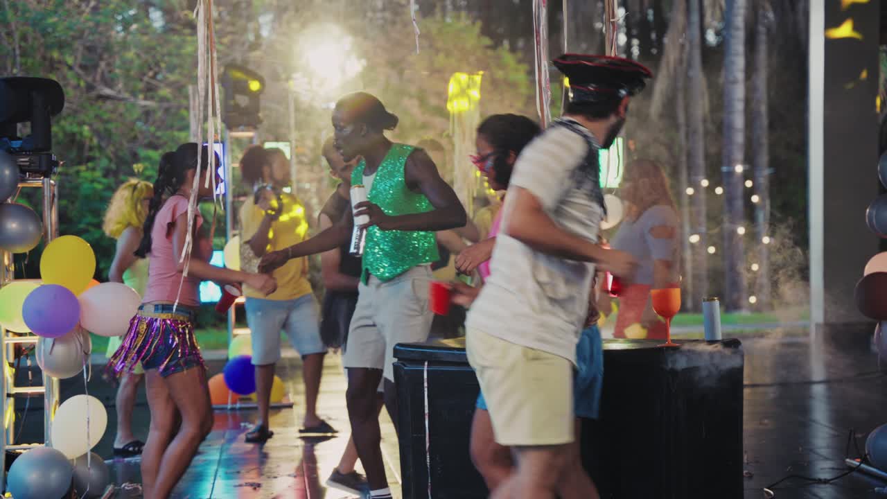 Vibrant Outdoor Night Party with Diverse Group Dancing and Celebrating