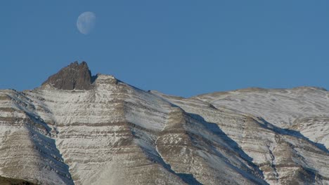 a full moon rises over the andes mountains in patagonia 3